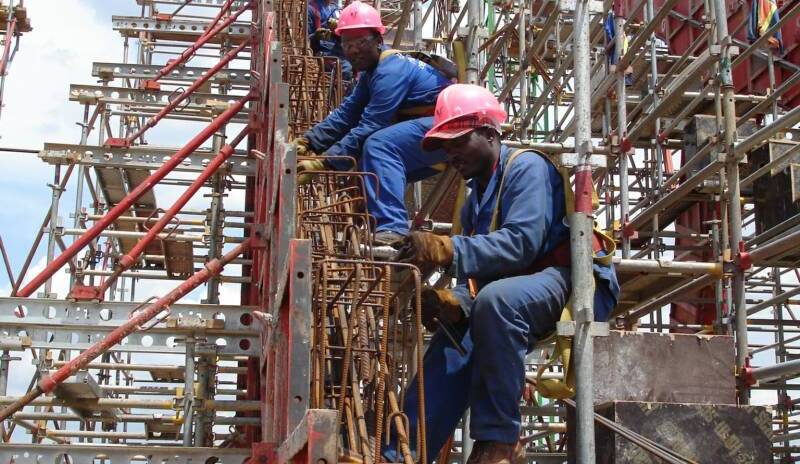 Welders Ghana team working on structural steel construction from scaffolding in Ghana