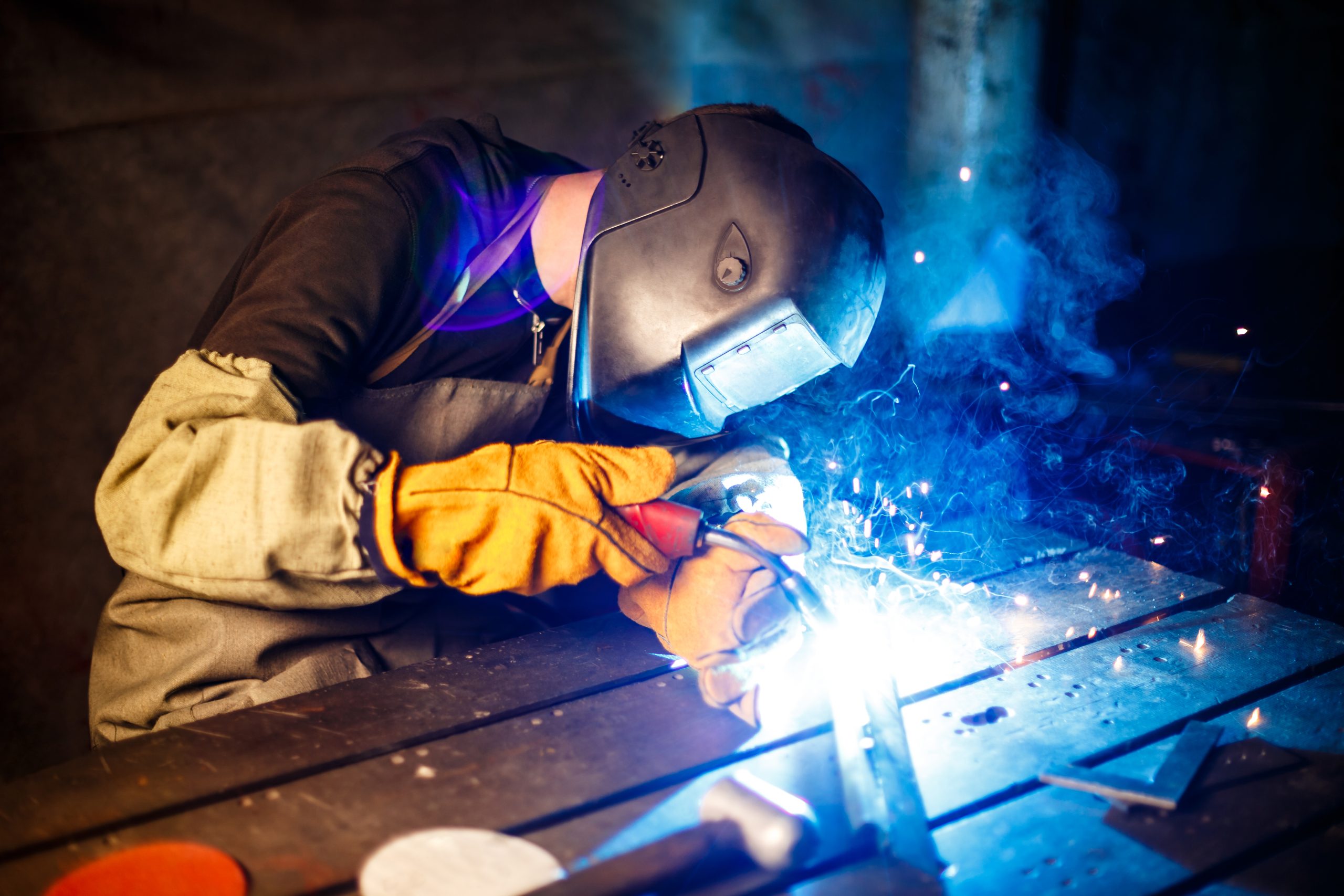Welders Ghana using plasma cutting equipment to cut metal at a fabrication plant in Ghana